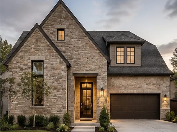 Single-storey stone cottage with a steep gable and attached garage